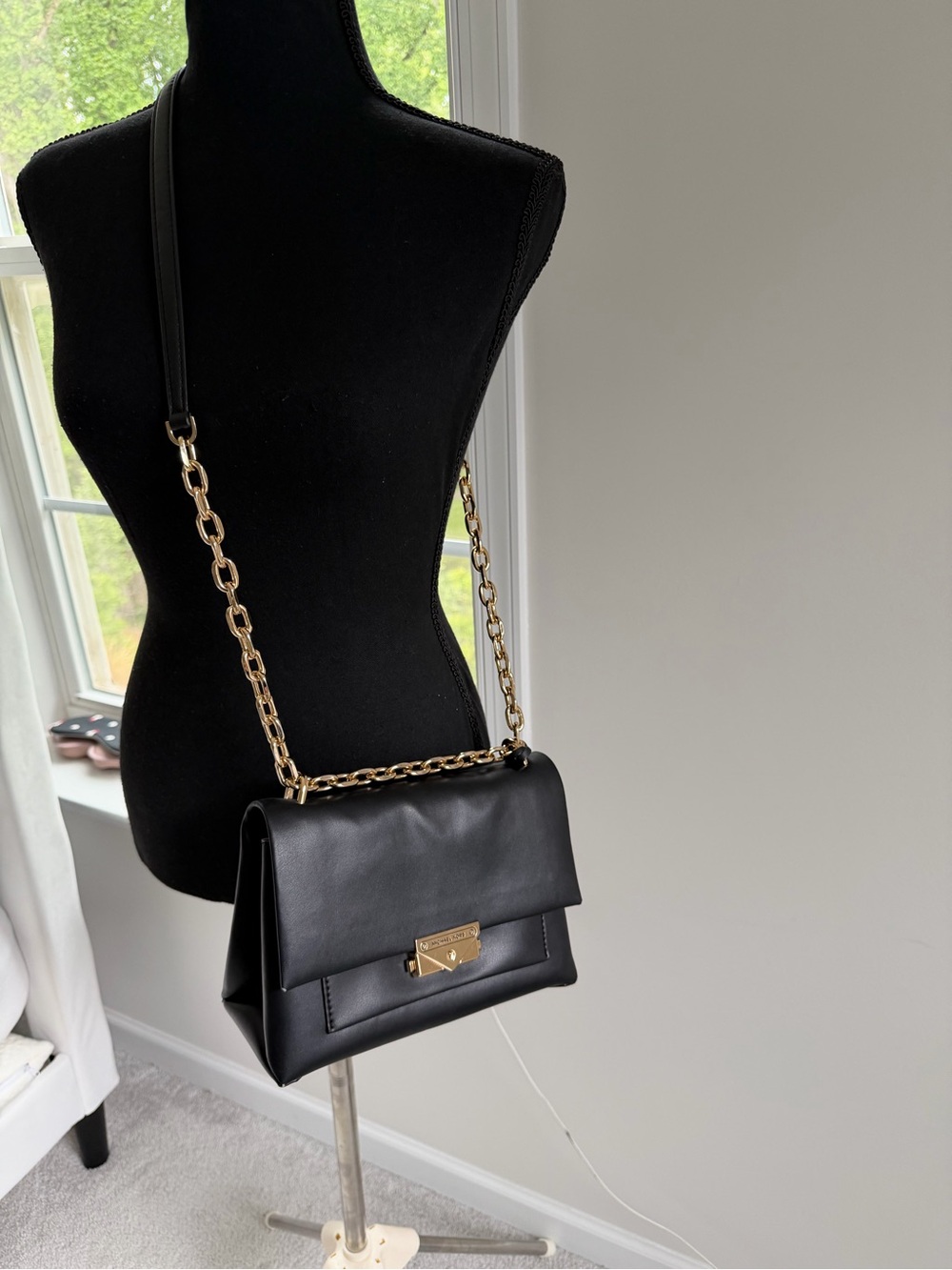 Elegant Michael Kors black shoulder/crossbody bag featuring gold-tone chain